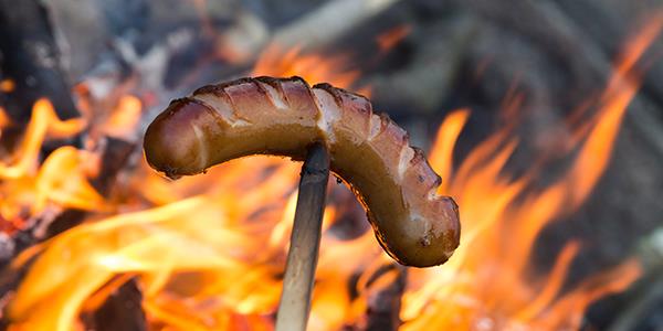 Sausage cooking on an open fire
