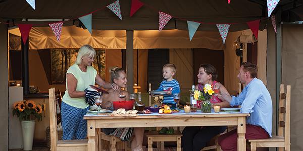 Family together eating dinner around a table