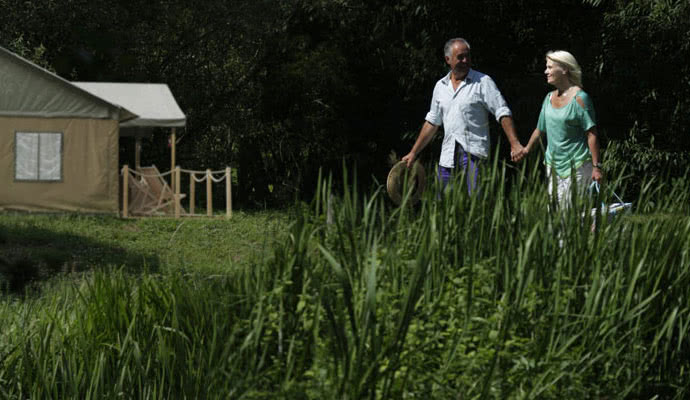 Couple enjoying a walk around the peaceful glamping site