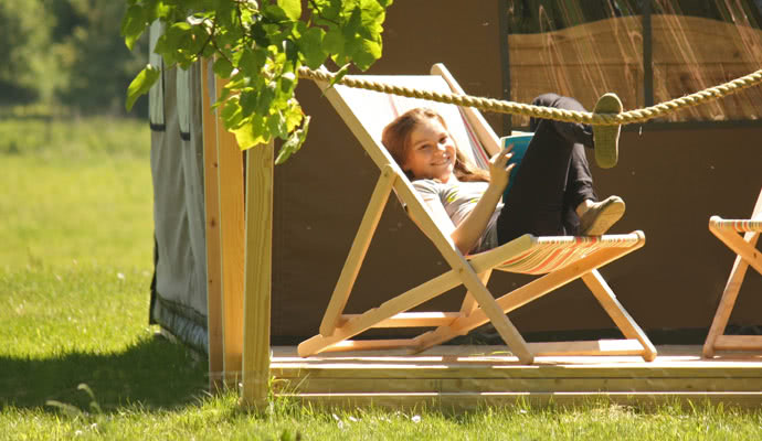 Happy camper relaxing in the deck chairs