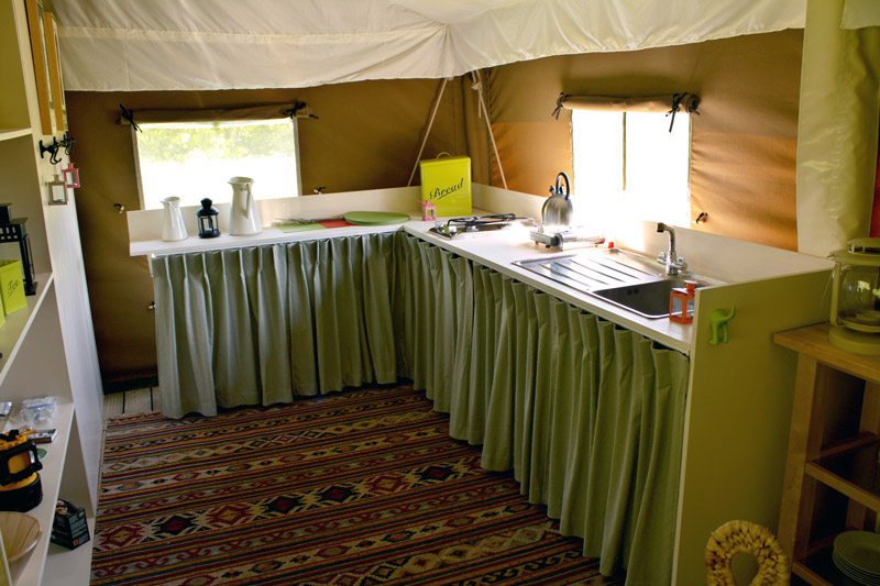 The kitchen area contains a sink and a twin gas hob
