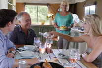 Family having a meal inside a glamping tent - thumbnail